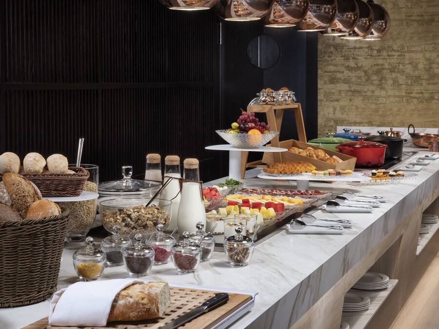 A buffet with various food items and beverages.