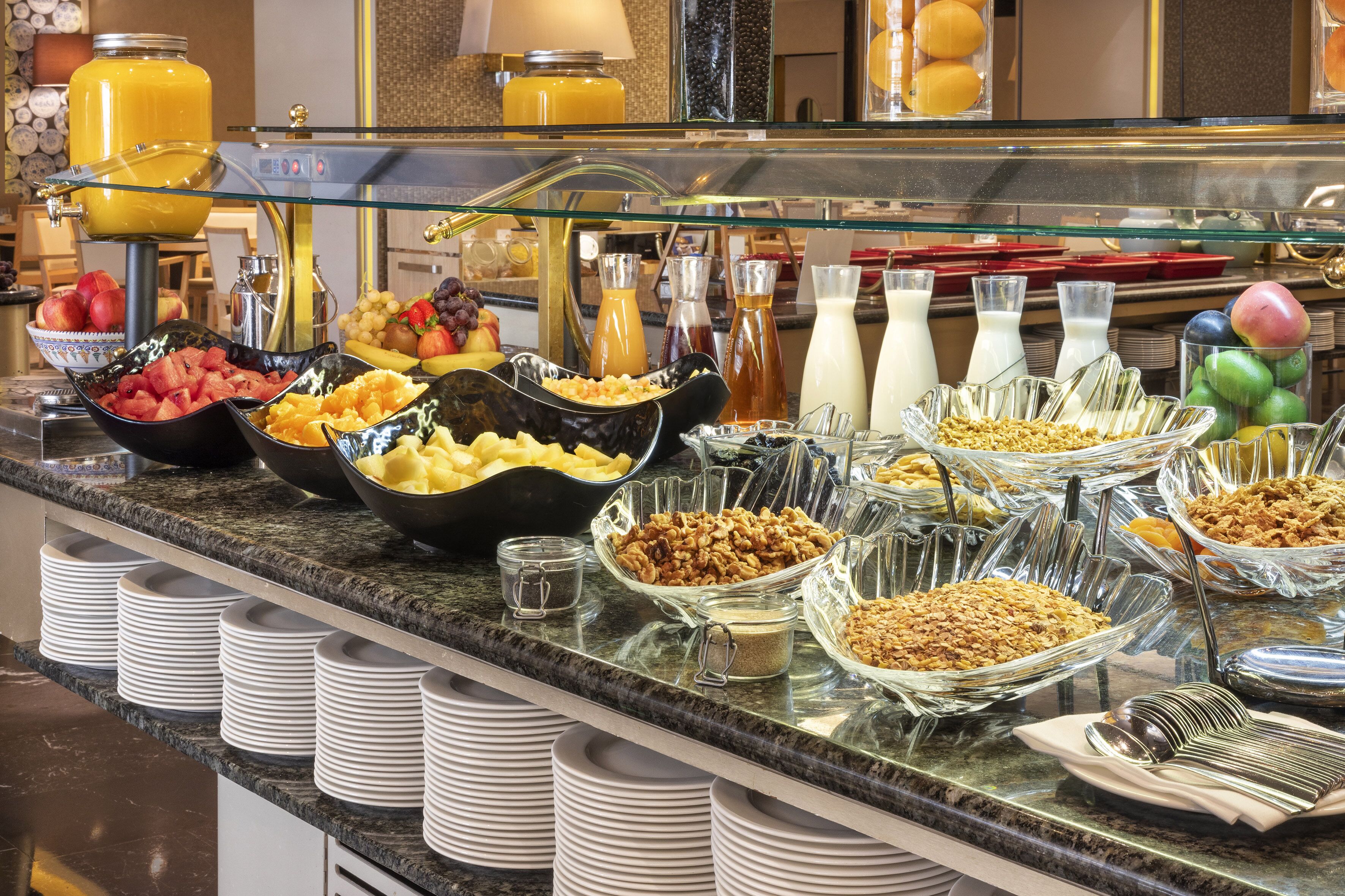 A buffet with various food items and beverages.
