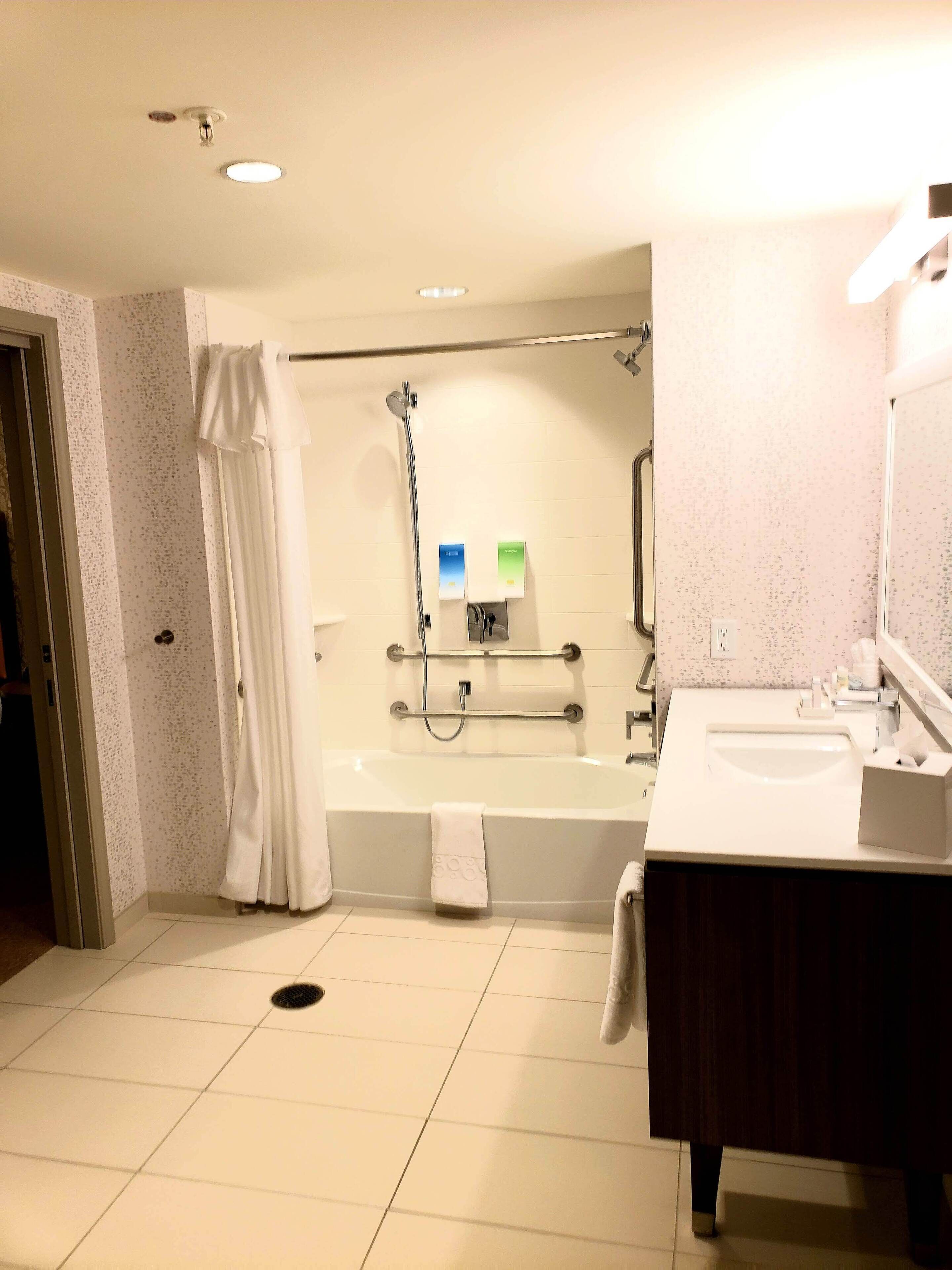 A bathroom with a bathtub, a shower, a sink, and a toilet.