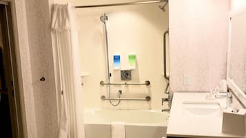 A bathroom with a bathtub, a shower, a sink, and a toilet.