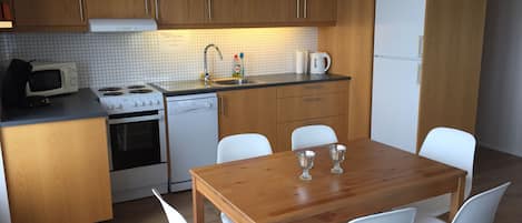 Family Apartment, Multiple Beds, Ocean View | Private kitchen | Full-size fridge, microwave, oven, stovetop