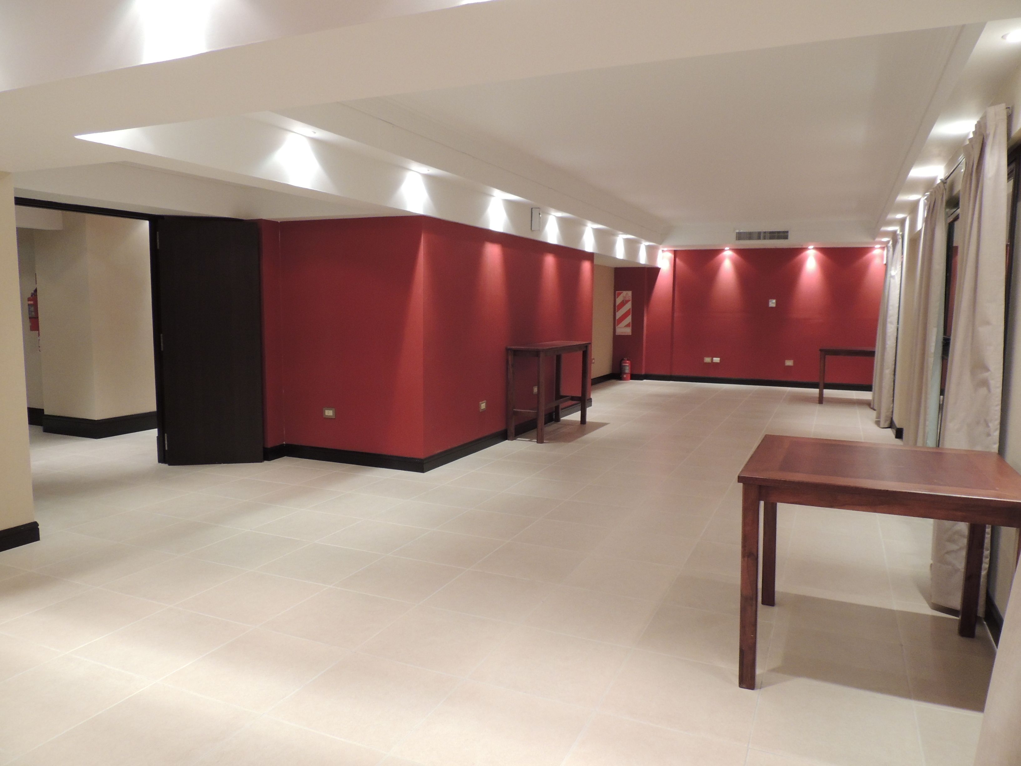 A hallway with red walls and a wooden table.