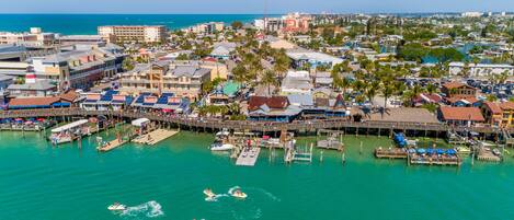 A coastal town with a marina, boats, and buildings.
