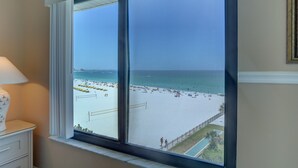 A room with a large window overlooking a beach. - 🌞 Caprice Resort Unit #502 – Renovated Gulf Front Escape for Four Guests (St Pete Beach)