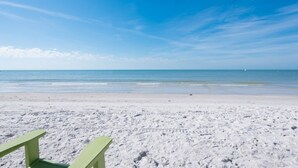 A beach with a clear sky and calm sea.