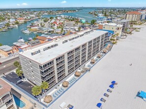 A hotel with a rooftop terrace, a pool, and a beachside location. - 🌊 Villa Madeira #304 — Fully Remodeled Gulf Front Luxury with Sweeping Views (Madeira Beach)
