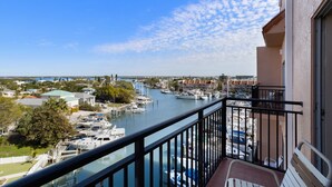A balcony with a view of a marina and surrounding buildings.