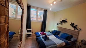 A hotel room with a bed, two chairs, a small table, and a window with curtains. - SEAHAUS FUERTE in a residential complex directly on the sea. (Corralejo)