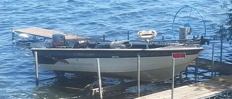 A boat named 'Crestliner' docked at a pier.