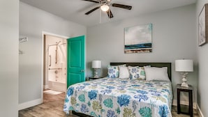 A bedroom with a bed, a ceiling fan, a green door, a shower, and a painting on the wall. - HUGE POOL, STOCKED GAME ROOM, SLEEPS 50, 1 min WALK TO BEACH, INCREDIBLE VIEWS!! (North Myrtle Beach)