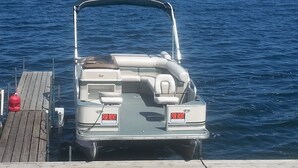 A boat docked at a wooden pier with a 'FOR RENT' sign on the back. - Cottage 5 is great for family gatherings, & fishing on Lake Osakis! (Osakis)
