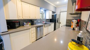 Enjoy cooking and dining in this well-equipped kitchen with a dishwasher, microwave, toaster, and coffee maker.