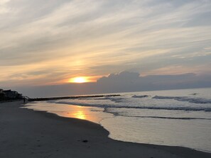 A beach with a sunset, waves, and a pier. -  LOWER FALL & WINTER RATES — Your Folly Beach Getaway Is Calling! (Folly Beach)