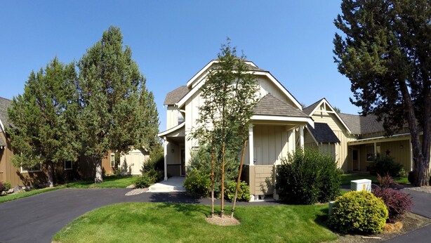 A single-story house with a front porch, a driveway, and a well-maintained lawn. - Desert Sky, Eagle Crest Home. Golf on site, close to pool (Redmond)