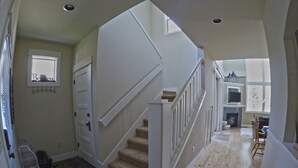 A staircase leading to a second floor with a fireplace and a dining area. - Desert Sky, Eagle Crest Home. Golf on site, close to pool (Redmond)