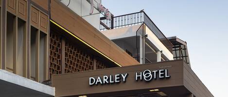 The exterior of Darley Hotel with a modern facade, a covered entrance area, and a sign indicating a 5-star rating.