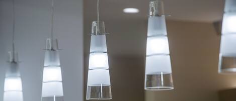 A series of hanging pendant lights with a clear, cylindrical design.
