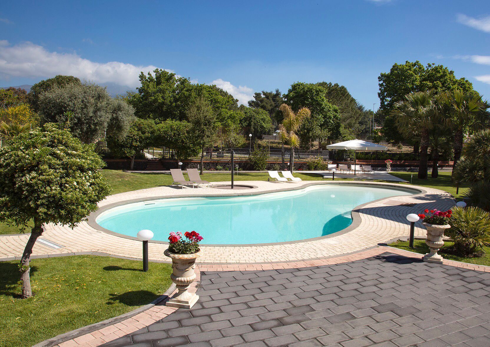 Seasonal outdoor pool, open 9:00 AM to 7:30 PM, pool umbrellas