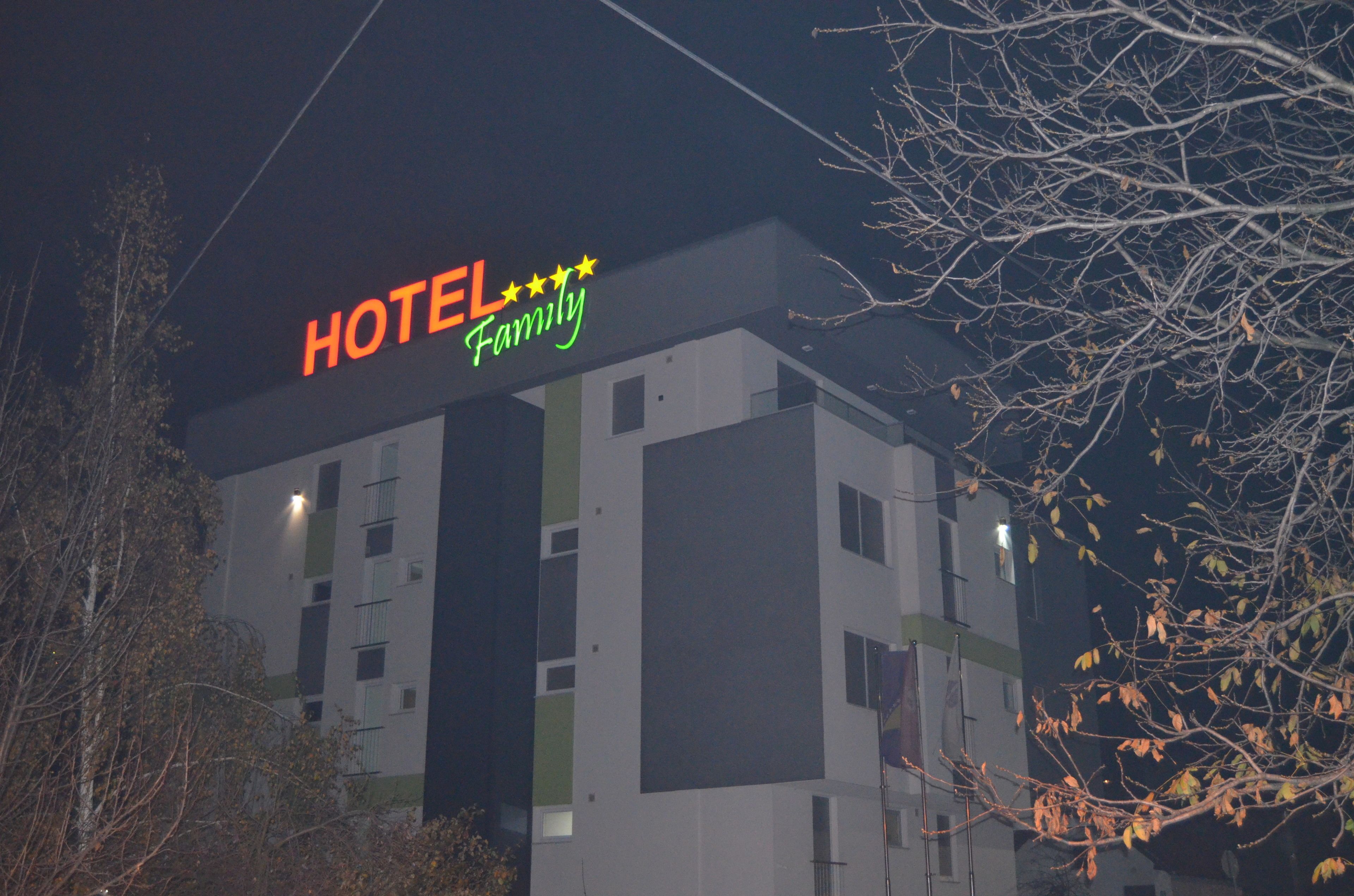 A hotel with a sign reading "HOTEL Family" and a five-star rating.