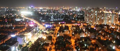 A nighttime cityscape with illuminated buildings and streets.