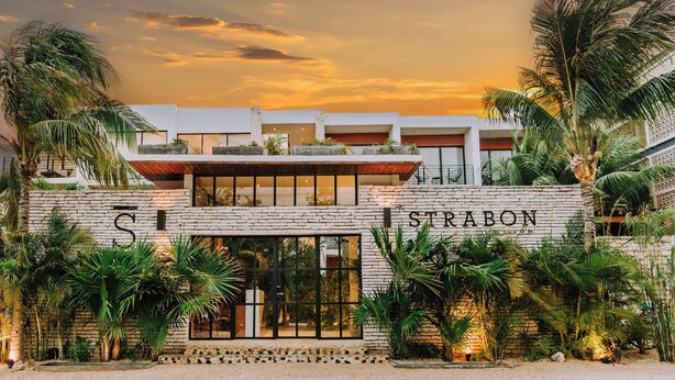 A hotel with a stone facade, large windows, and tropical plants. - The Strabon Tulum (Tulum)