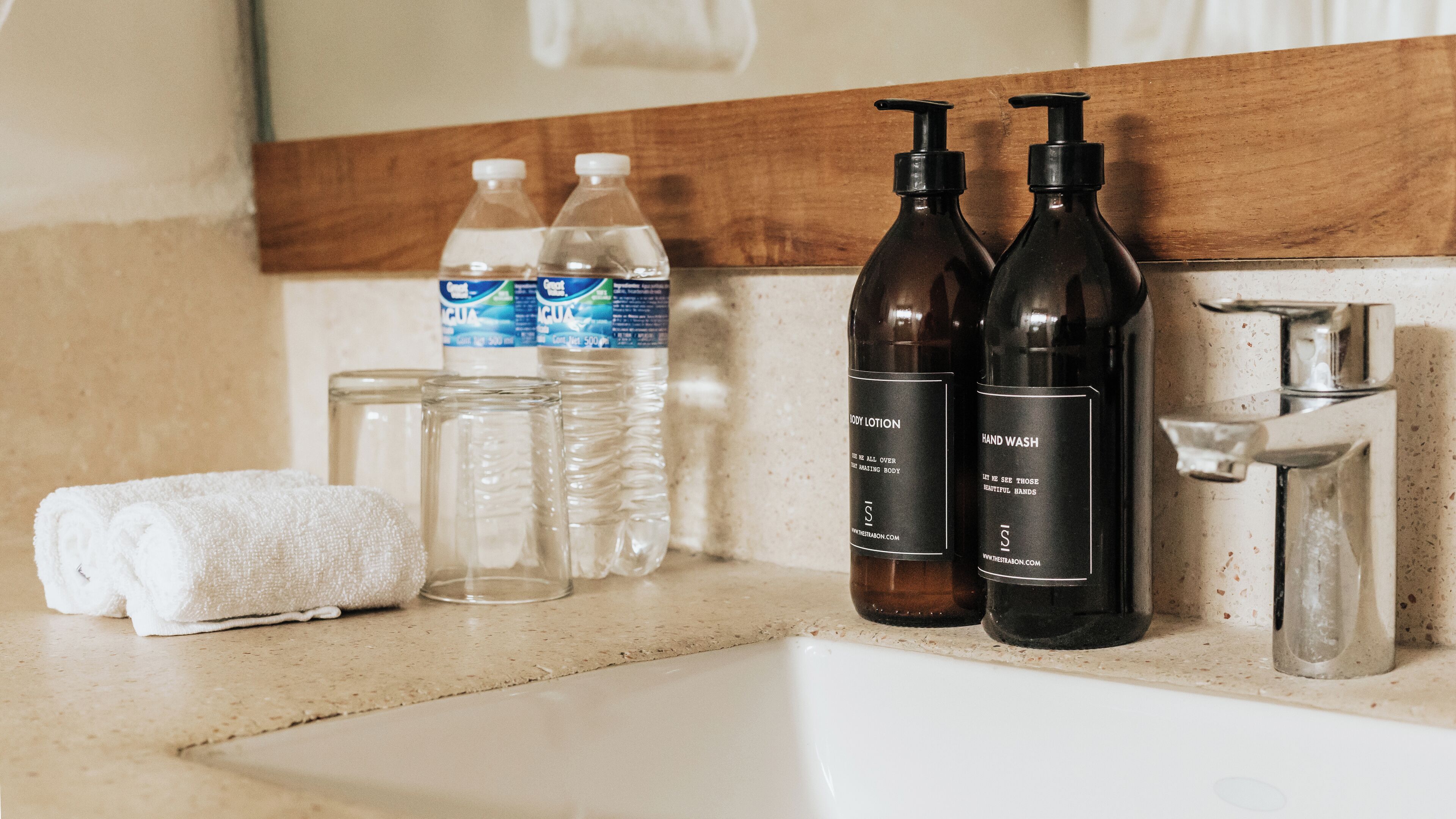 deluxe room with two queen beds | bathroom | free toiletries, hair dryer, towels