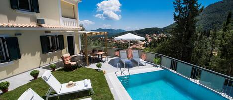Outdoor pool, open 9 AM to 6 PM, pool umbrellas, pool loungers