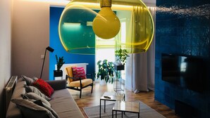 A modern living room with a sofa, a coffee table, and a TV. - Piper Zajezdnia Blue (Poznan)