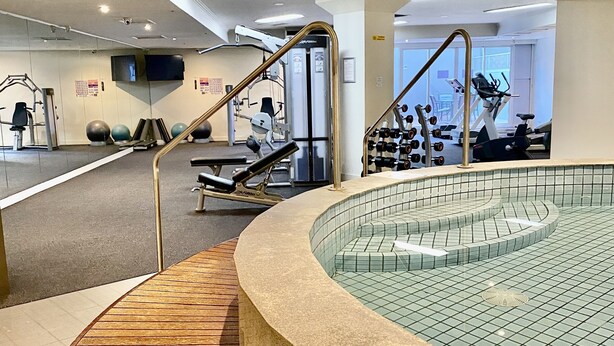 A gym with exercise equipment, a pool, and a staircase leading to a higher level. - Riverside. Walk to Crown, CBD & MCG. Free Secure Carpark. (MELBOURNE)