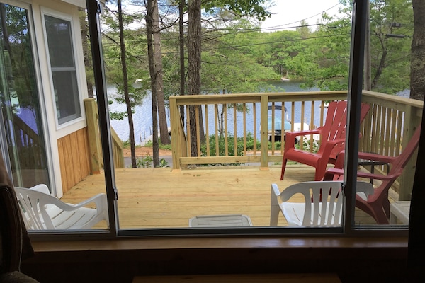 View of deck and lake from living room window.