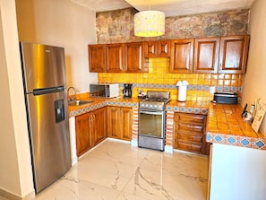 Enjoy cooking in this fully equipped kitchen with a gas stove, microwave, coffee maker, and refrigerator.