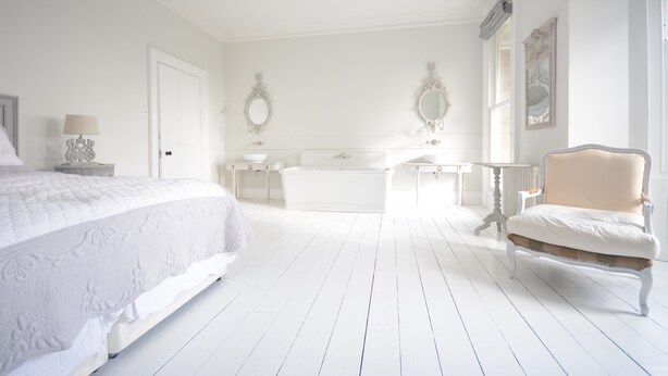 A white bedroom with a bed, a chair, a vanity, and a bathtub. - High View Large Luxury House (London)