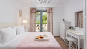 A bedroom with a bed, a dresser, a desk, and a window with curtains.