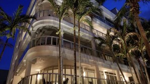 A multi-story hotel with balconies, palm trees, and a night-time setting. - 4,000+ sq ft beachfront residence + PRIVATE BEACH Resort & Spa by Marriott (Fort Lauderdale)