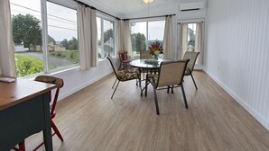 A dining area with a round table, chairs, and a view of the outdoors. - Historic Building, Quiet Location in Beautiful Lancaster County, Stella Side (Terre HIll)