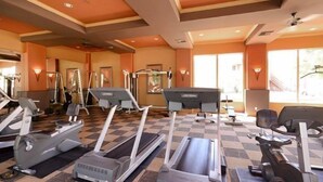 A gym with treadmills, elliptical machines, and weight equipment.