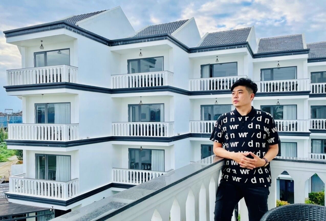 A multi-story building with balconies and large windows.