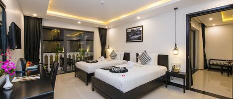 A modern hotel room with two beds, a dining area, and a large mirror.