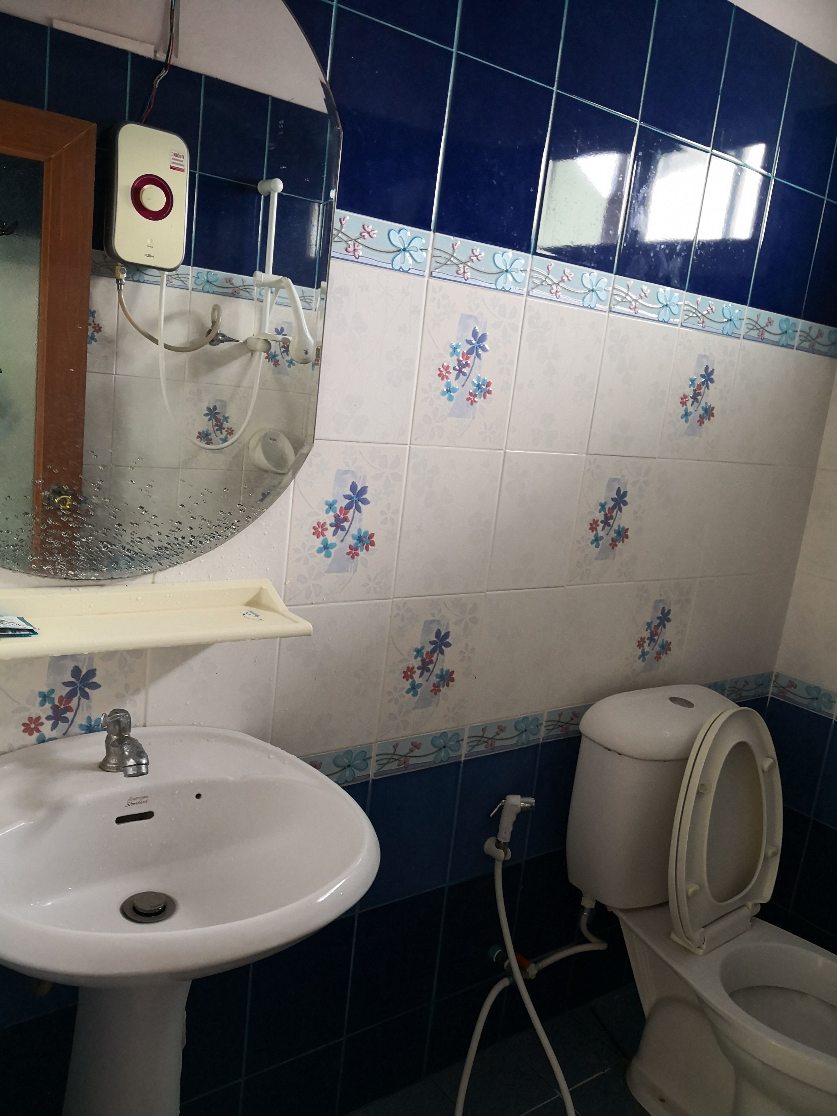A bathroom with a sink, mirror, and toilet.