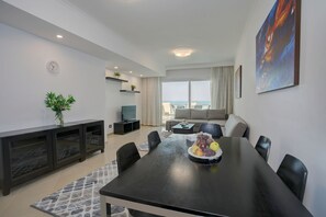 Family Suite, 2 Bedrooms, Pool View, Beachside | Living area | LCD TV
