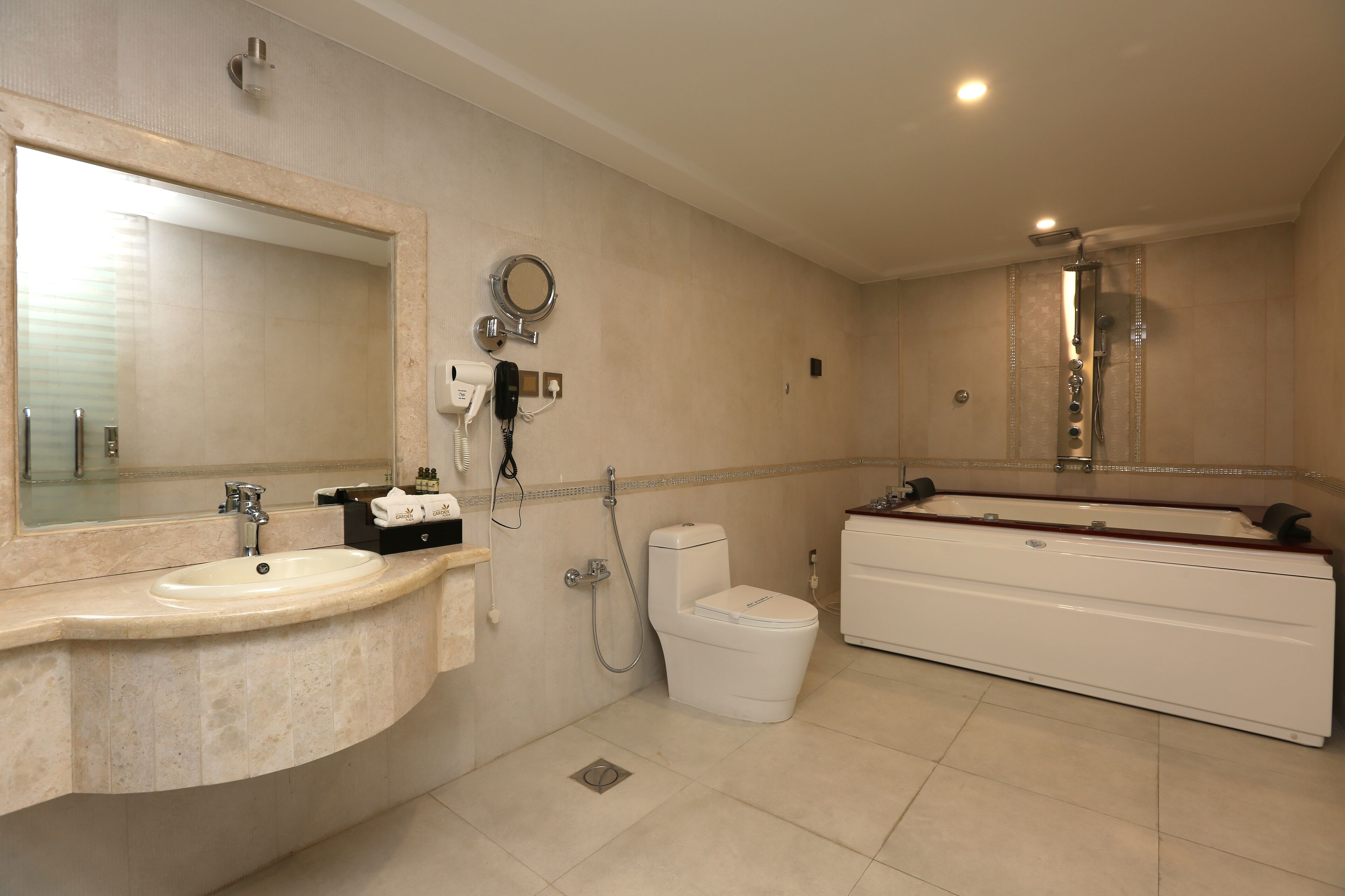 A modern bathroom with a sink, toilet, and bathtub.