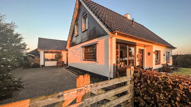 A modern two-story house with a steeply pitched roof, large windows, and a covered patio area. - 1 bedroom cozy home in Sprundel (Sprundel)