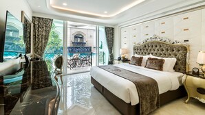 A luxurious bedroom with a large bed, a TV, and a balcony with a view. - LK Emerald Beach (Pattaya)