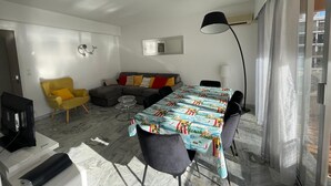 A modern living room with a dining table, sofa, and chairs. - APARTMENT 6 pers 150m SEASIDE SEA LARGE TERRACE SEA VIEW PARKING (Roquebrune-Cap-Martin)