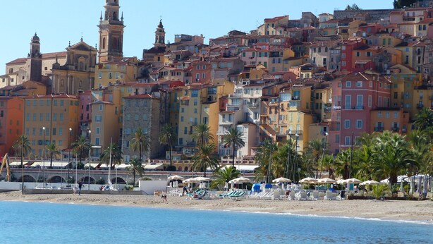 A coastal town with colorful buildings, a beach with umbrellas, and a prominent church tower. - APARTMENT 6 pers 150m SEASIDE SEA LARGE TERRACE SEA VIEW PARKING (Roquebrune-Cap-Martin)
