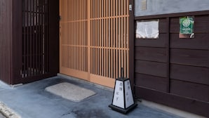 A traditional Japanese building with a wooden entrance and a sliding door.