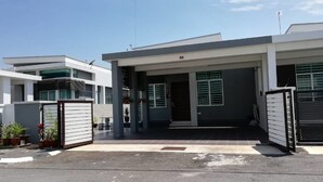 A modern two-story building with a gated entrance, a covered driveway, and a satellite dish on the roof. - KKP Homestay Alor Setar (Alor Setar)