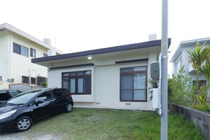 A modern two-story house with a flat roof and large windows. - South Window Onna-son (Onna)