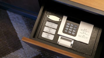 A hotel room's control panel with a keypad, a card reader, and a small booklet.
