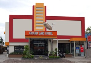 The Grand Sari Hotel with a prominent sign, a satellite dish, and an ATM on the right. - Grand Sari Hotel (Padang)